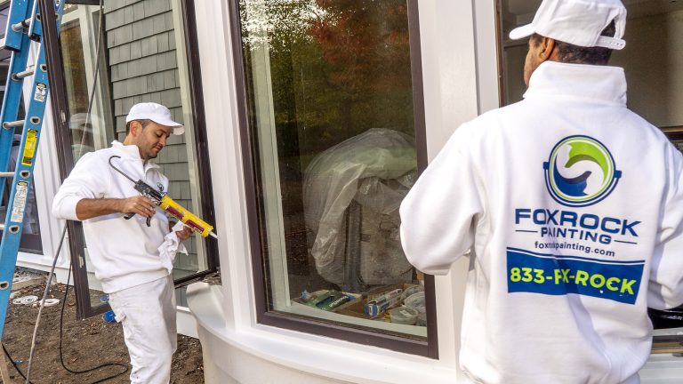 Fox Rock Painting employees painting home's exterior windows