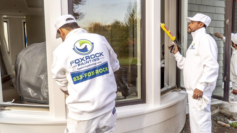 Fox Rock Painting employees painting home's exterior windows